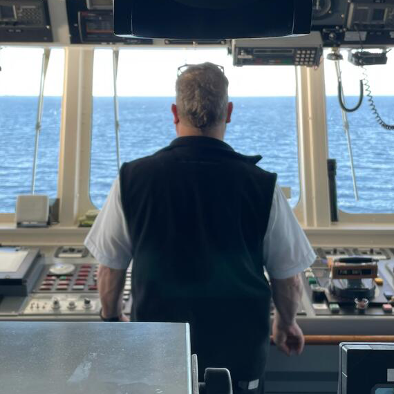 Person at the controls of a cargo ship